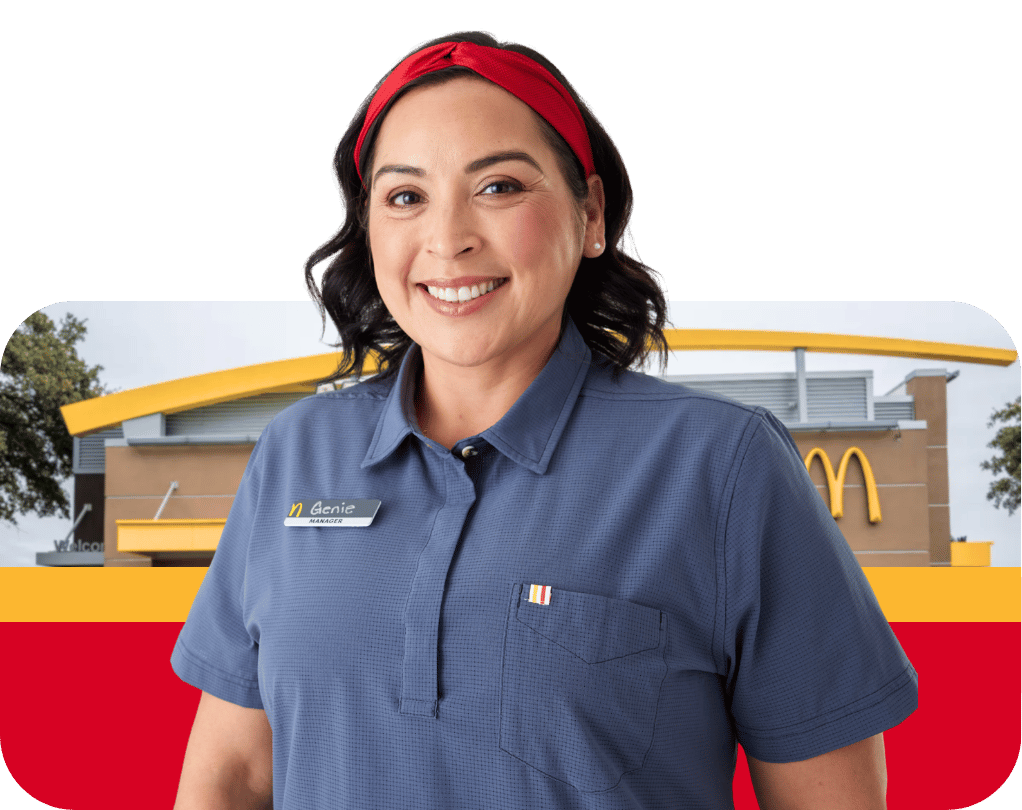 Female McDonald's employee wearing blue uniform polo and name badge in front of restaurant