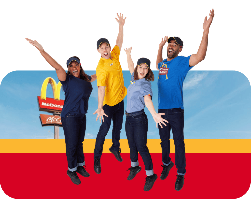 McDonald's employees wearing branded uniforms jumping and celebrating in front of restaurant background